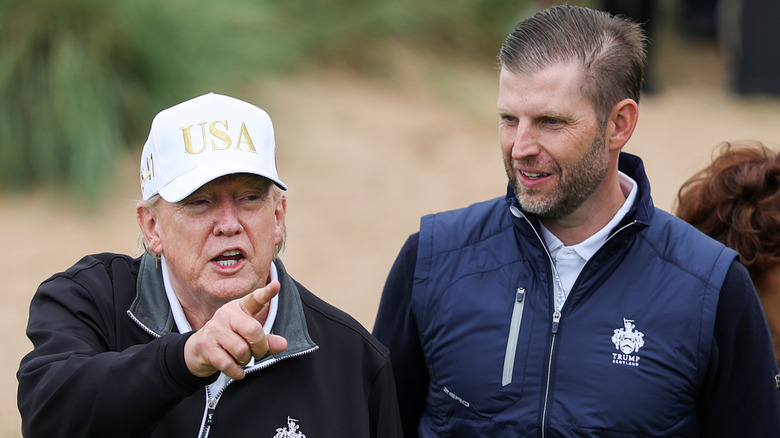 Donald Trump pointing with Eric Trump on Turnberry course