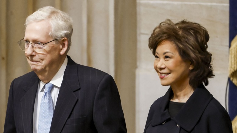 Mitch McConnell and Elaine Chao smiling as they arrive at Donald Trump's 2025 inauguration