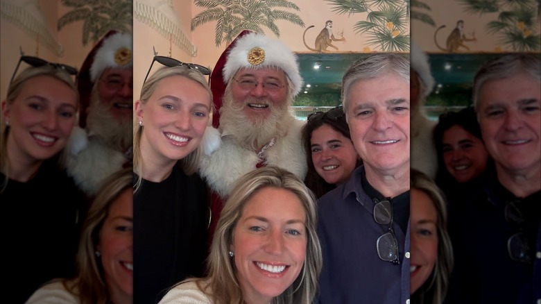 Sean Hannity and Ainsley Earhardt posed with others during a Christmas celebration in December 2024 (2024)