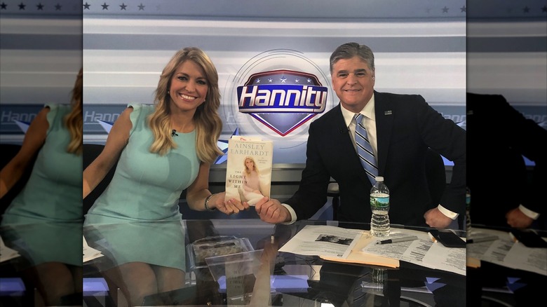 Sean Hannity and Ainsley Earhardt hold up her book 'The Light Within Me' on the set of his show 'Hannity' in April 2018 (2018)