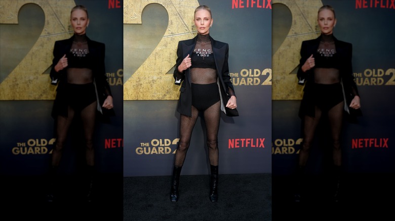 Charlize Theron on the Netflix red carpet in a fishnet catsuit and blazer.