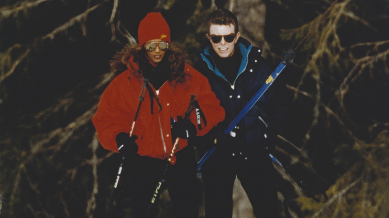 David Bowie is providing ski lessons to his wife Iman Bowie, Gstaad, 4th January 1993