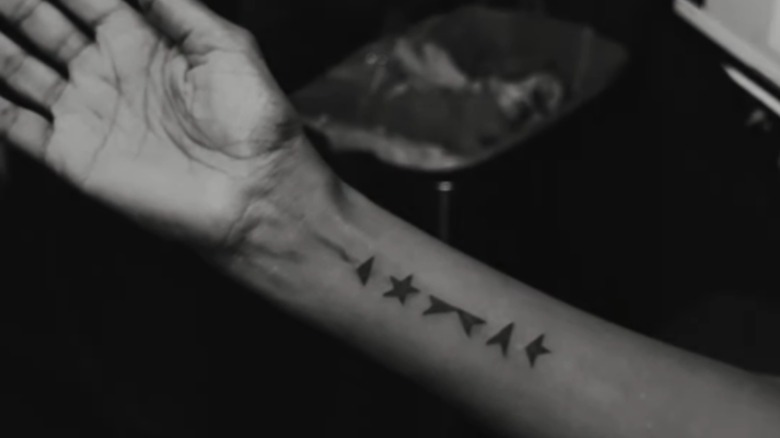 Iman's arm showing off her Bowie tattoo.