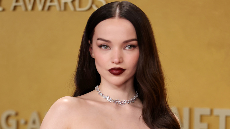Dove Cameron smirking on the red carpet in March 2026
