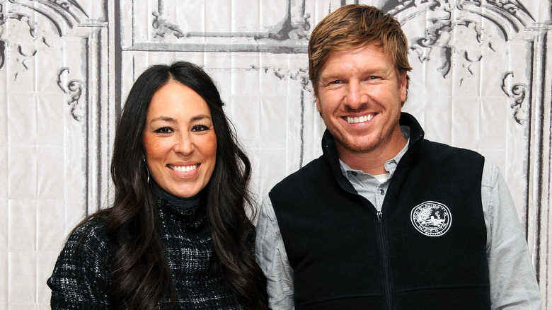 Fixer Upper's Chip and Joanna Gaines smiling for the camera at an event
