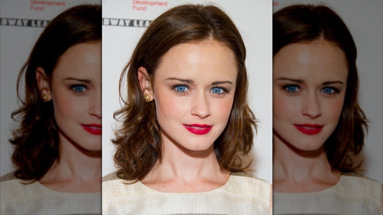 Alexis Bledel smiles with red lipstick