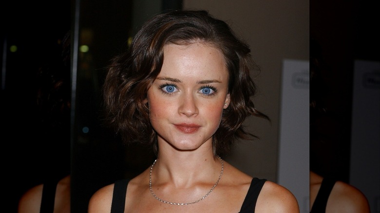 Alexis Bledel in a black dress with silver necklace