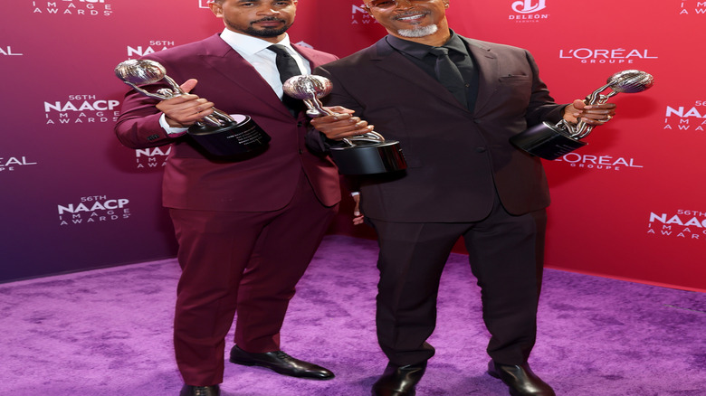 Damon Wayans Jr. and Damon Wayans posing with awards