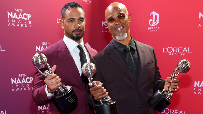 Damon Wayans Jr. and Damon Wayans posing with awards