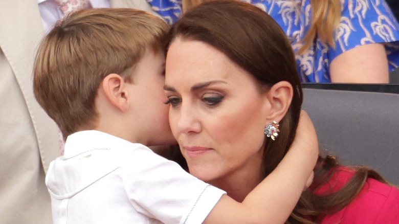 Prince Louis whispering into Princess Catherine's ear at Wimbledon