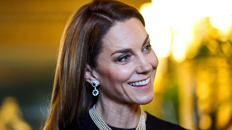 Princess Catherine smiling and tilting her head at the 2023 Royal Collection Exhibition