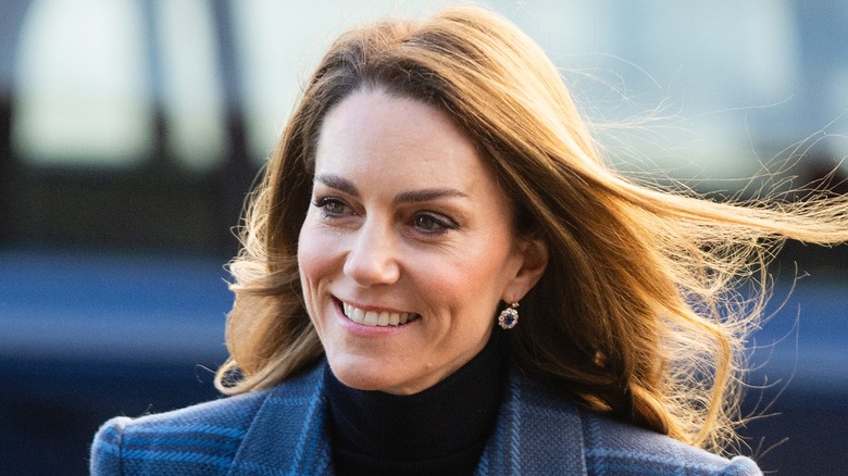 Princess Catherine smiling during a trip to Scotland in 2026 with her hair blowing in the wind