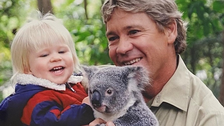 Steve Irwin holding son Robert Irwin and a koala