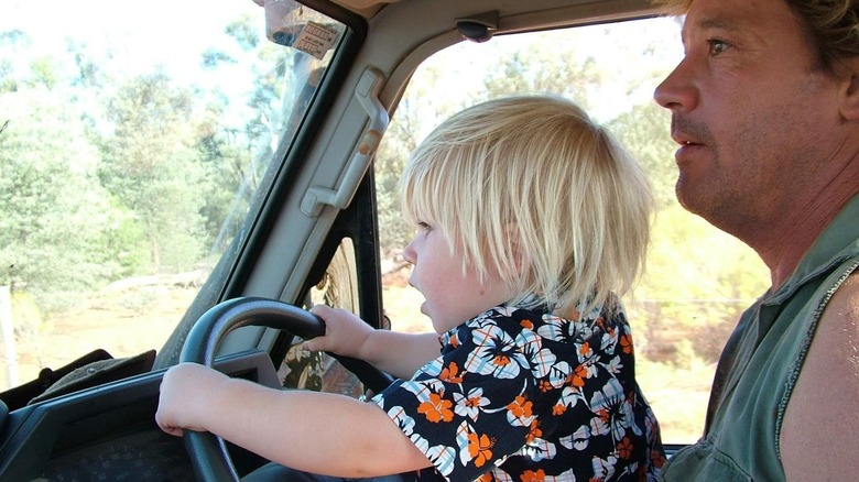 Young Robert Irwin driving with dad Steve Irwin in his truck