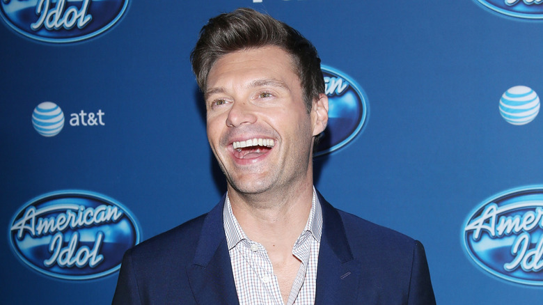 Ryan Seacrest wearing a blue jacket in 2013