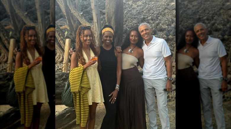 Outside in a wooded area, the Obama family standing together.