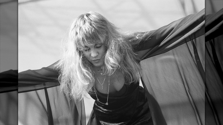 Stevie Nicks of Fleetwood Mac performs in a 1978 wearing a sheer top over her dress