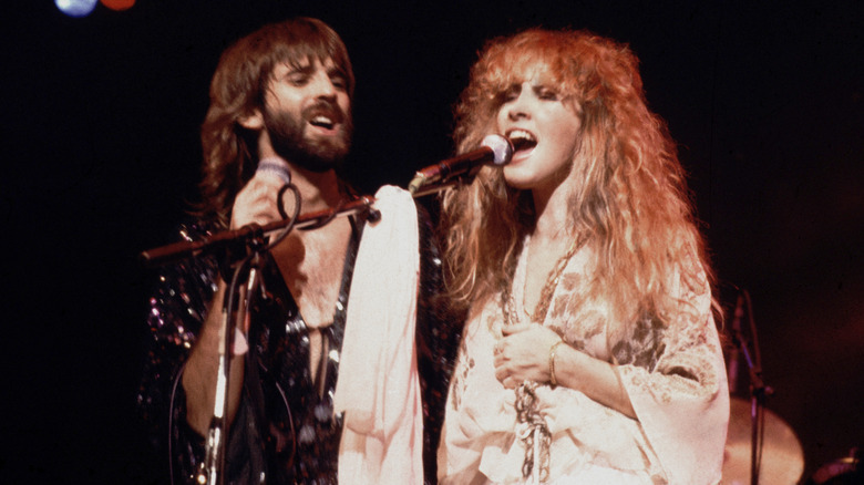Kenny Loggins in a shiny jumpsuit and Stevie Nicks is wearing a white bell-sleeved dress in 1978