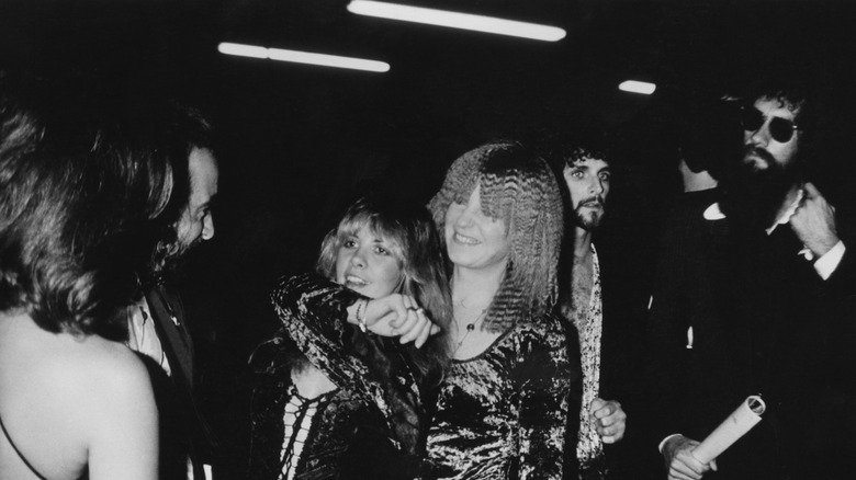 Black and white image of Christine McVie with her arm around Stevie Nicks at the Grammys in 1978