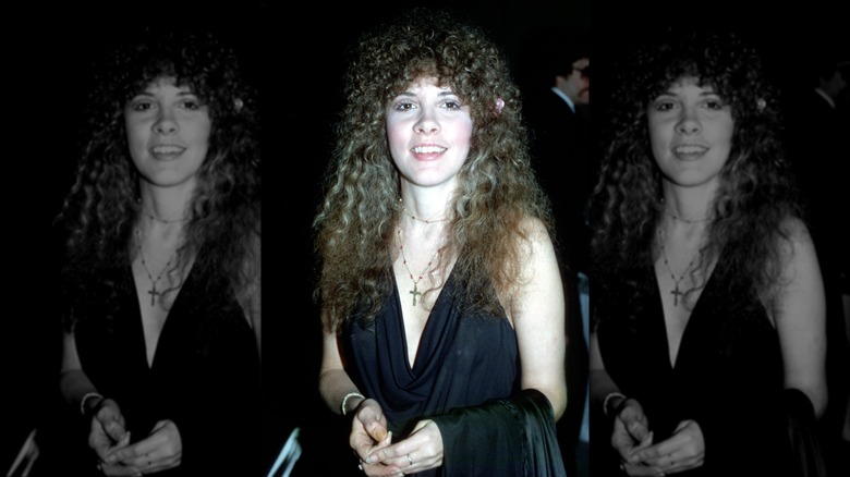 Stevie Nicks smiling at an event in 1975 with permed hair