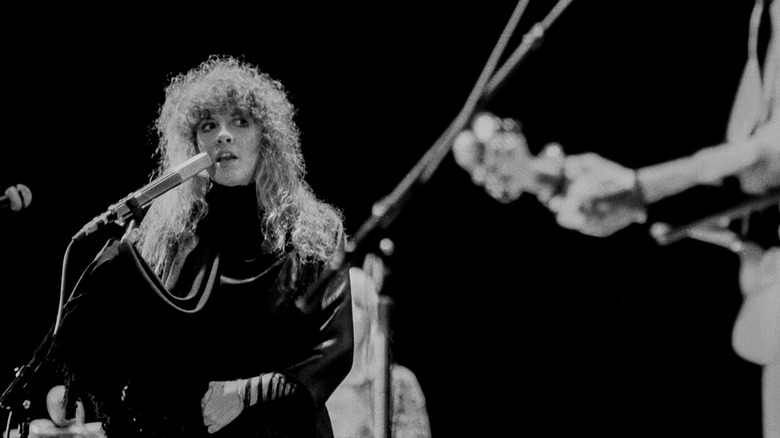 Black and white photo of Stevie Nicks performing in concert at the Inglewood Forum in 1979