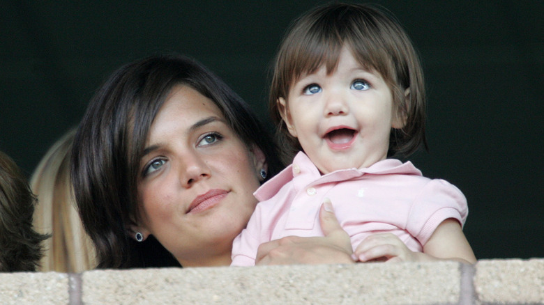Katie Holmes holding Suri Cruise as a baby