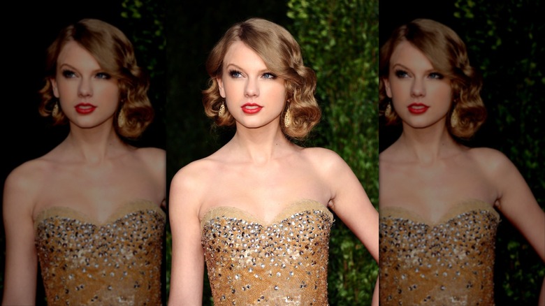 Taylor Swift in a gold dress, looking up and over.