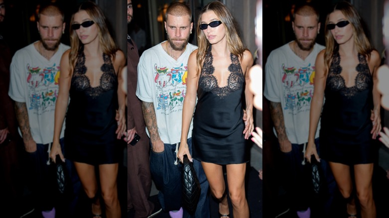 Justin Bieber in a T-shirt and Hailey Bieber in a black dress walking