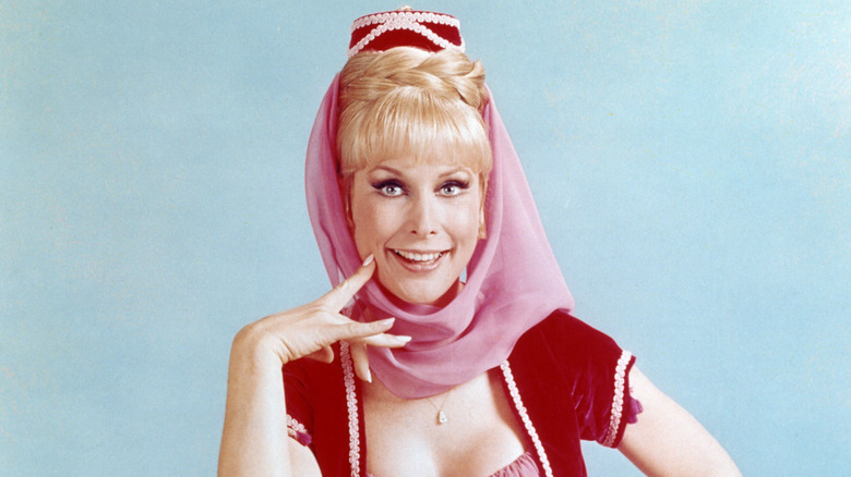 Barbara Eden, US actress, in costume sitting on a multi-coloured pile of cushions in a publicity portrait for the US television series, 'I Dream of Jeannie', circa 1967. The sitcom starred Eden as 'Jeannie'.