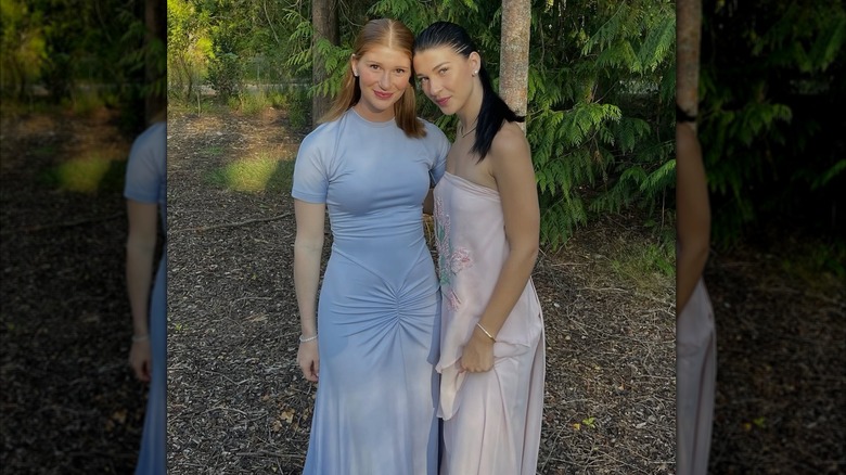 Jennifer Gates in a blue dress and Phoebe Gates in a pink dress