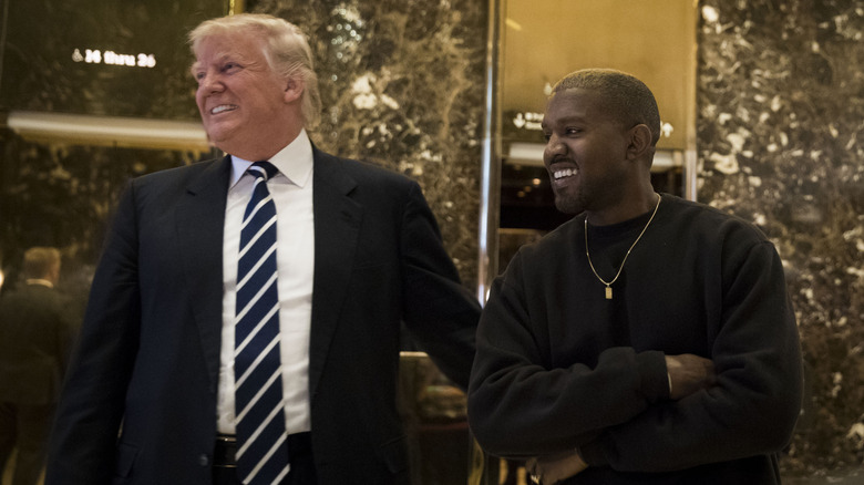Donald Trump and Kanye West stand together in the lobby at Trump Tower, December 13, 2016 in New York City.