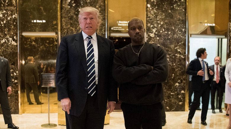 Donald Trump and Kanye West stand together in the lobby at Trump Tower, December 13, 2016 in New York City.
