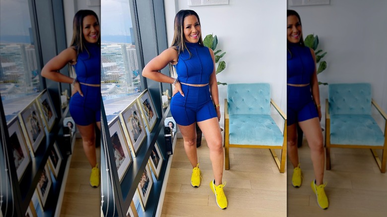 Page Turner posing in bright blue two-piece and sneakers