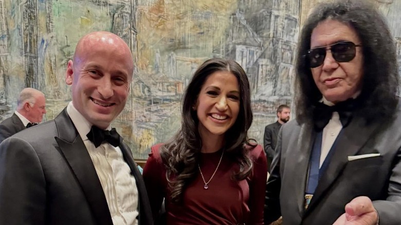 Stephen Miller and Katie Miller pose with Gene Simmons at a holiday party (2025)