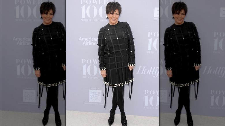 Kris Jenner smiles in a black dress