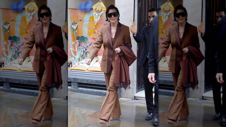 Kris Jenner walks in a brown suit