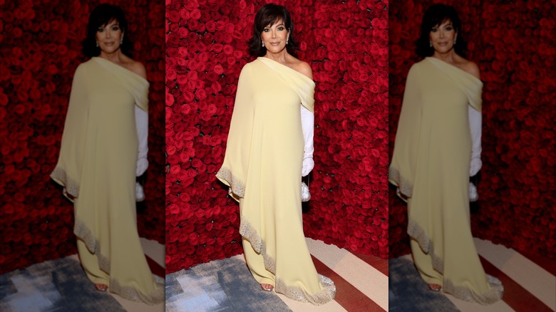 Kris Jenner smiling in a yellow gown