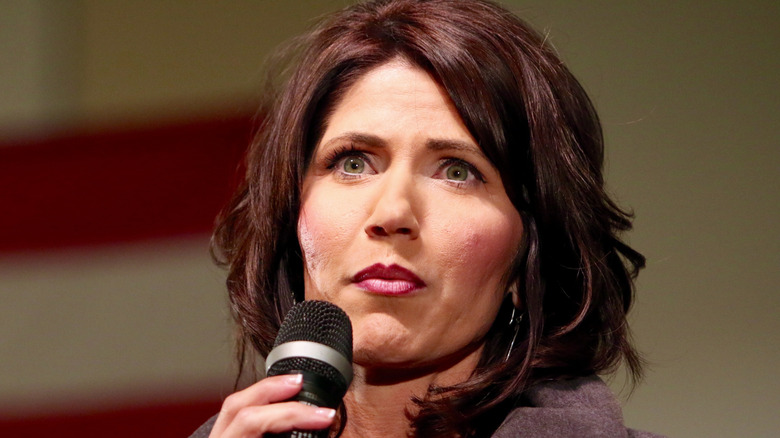 Kristi Noem speaking at a political rally in Iowa.