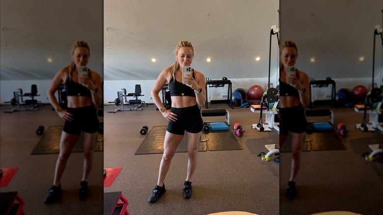 Lindsey Vonn in a home gym wearing a black sports bra and shorts