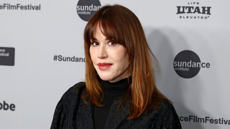 Molly Ringwald posing with a bold red lip at the 2026 Sundance Festival