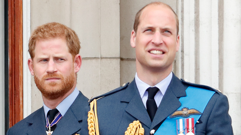 Prince Harry, Duke of Sussex and Prince William, Duke of Cambridge watch a flypast to mark the centenary of the Royal Air Force from the balcony of Buckingham Palace on July 10, 2018 in London, England.