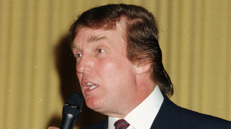 Donald Trump speaks into a microphone onstage at the Mar-A-Lago estate in Palm Beach, Florida, on March 15, 1997 (1997)