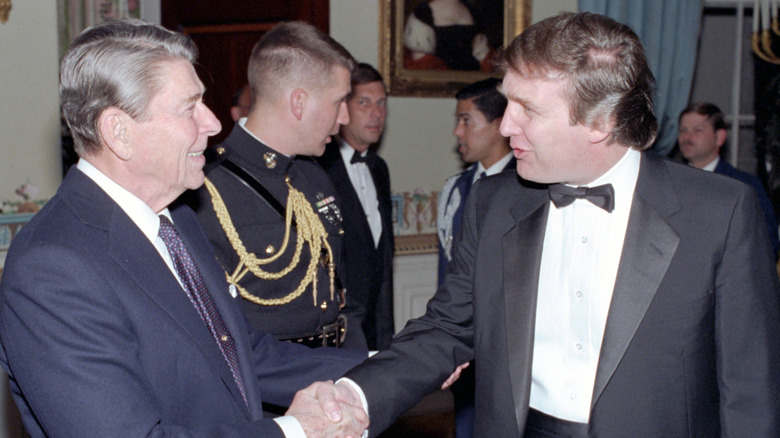 President Ronald Reagan shakes hands with Donald Trump at the White House's Blue Room in Washington, D.C., on November 3, 1987 (1987)