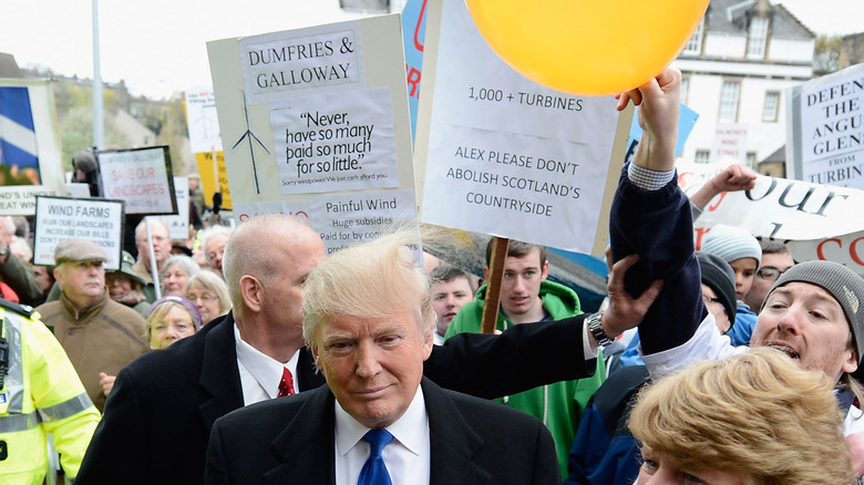 Donald Trump is hit on the head by a member of public holding a balloon following addressing the Scottish Parliament on April 25, 2012 (2012)