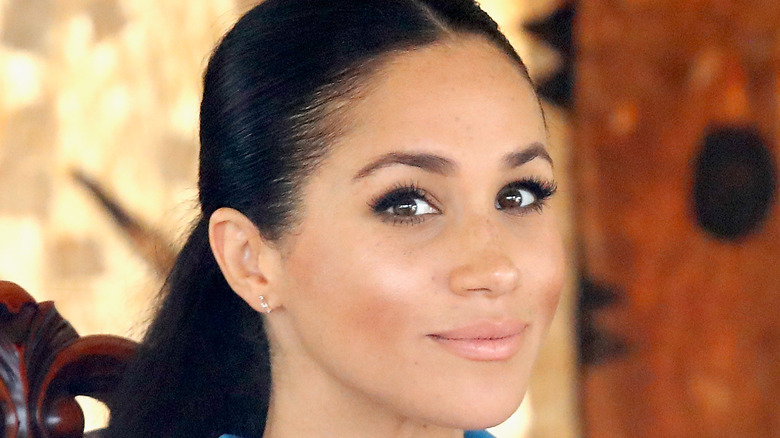 Meghan Markle looks knowingly at the camera