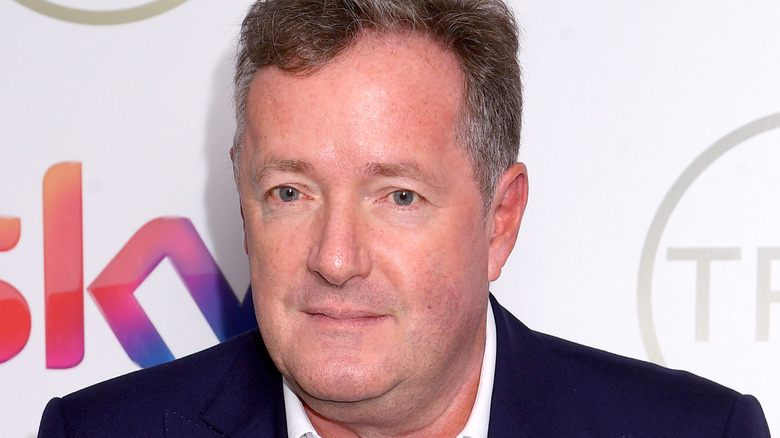 Piers Morgan poses at an event