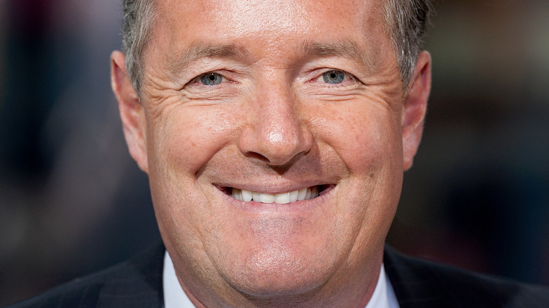 Piers Morgan smiling onstage