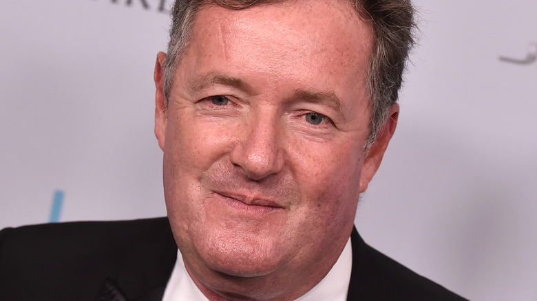 Piers Morgan smiles for a photograph.