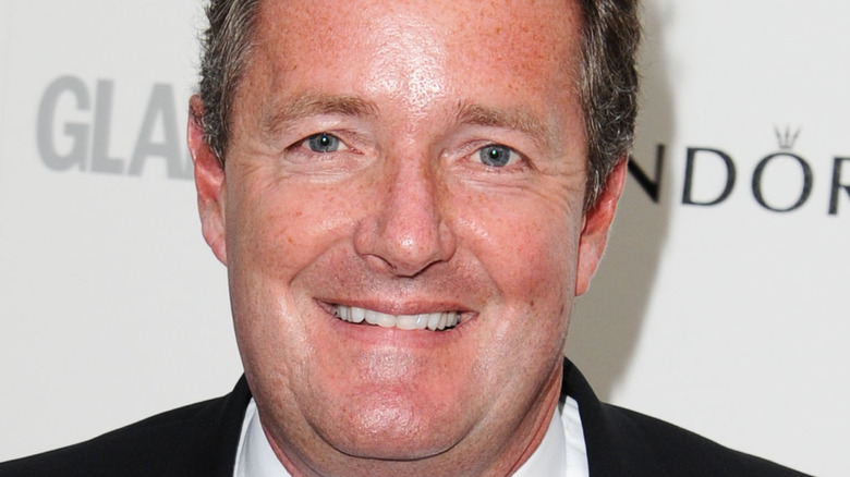 Piers Morgan smiles on the red carpet