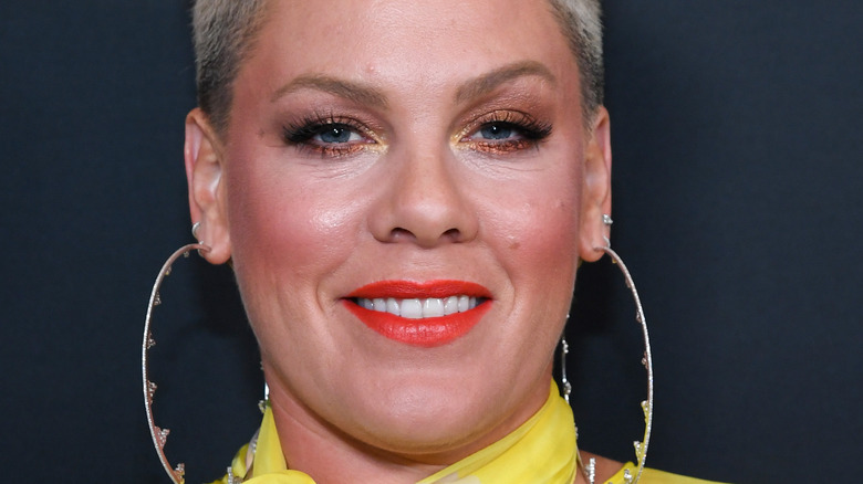 Pink smiling with large hoop earrings